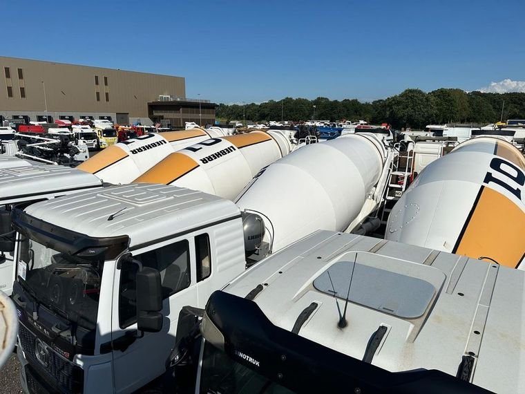 Rows of new Shacman mixer trucks with Liebherr drums lined up for export
